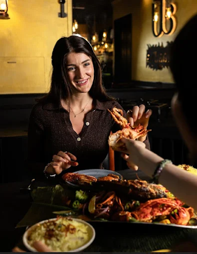 Guests sharing the Royal Waadiya Seafood Platter with crab, prawns and ghee rice at Waadiya Indian restaurant near Mulgrave